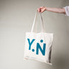 100% Bio-Baumwoll Tasche / Jutebeutel in creme weiß mit dem Yin Nation Logo.